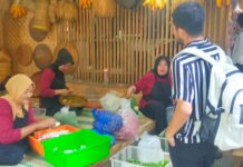 Mak-mak peracik bumbu dan sayuran sedang berbincang dengan pengunjung Pesona Kampung Sunda